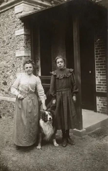Framed Print : Woman and girl with sheepdog outside a house, France Framed Print : Woman and girl with sheepdog outside a house, France
