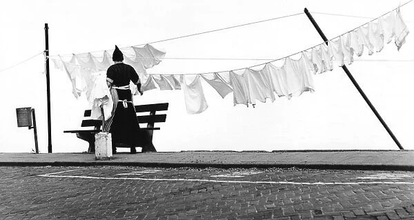 Woman hanging out the washing on a line