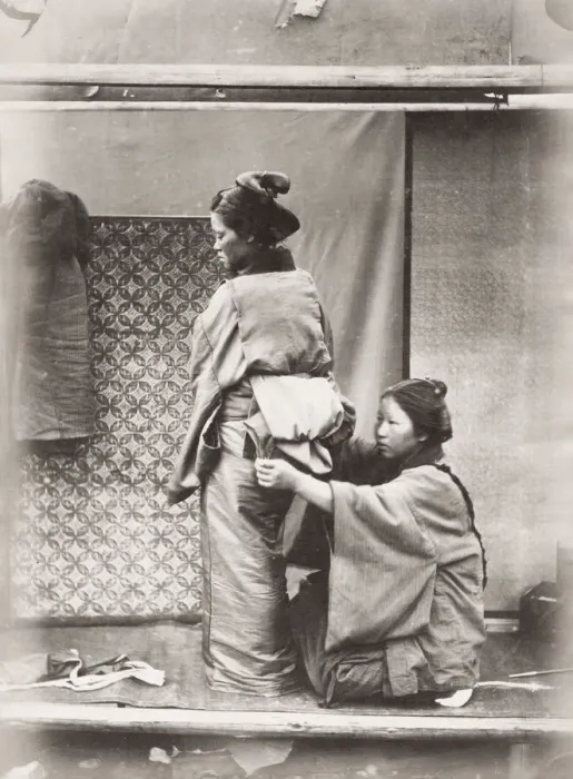 Framed Print : Woman having the obi sash tied over her kimono, Japan Framed Print : Woman having the obi sash tied over her kimono, Japan