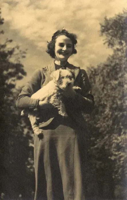 Framed Print : Woman holding a dog in a garden Framed Print : Woman holding a dog in a garden