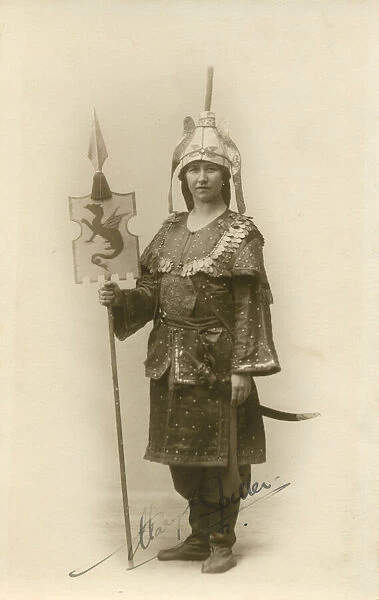 A woman in an interesting militaristic exotic costume, holding a standard. Date: c