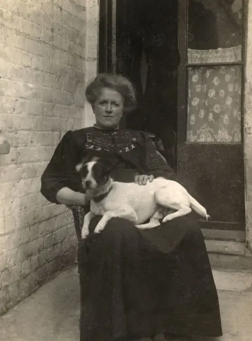 Framed Print : Woman with a Jack Russell terrier outside a house Framed Print : Woman with a Jack Russell terrier outside a house