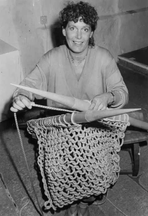 Framed Print : Woman knitting with six foot needles Framed Print : Woman knitting with six foot needles