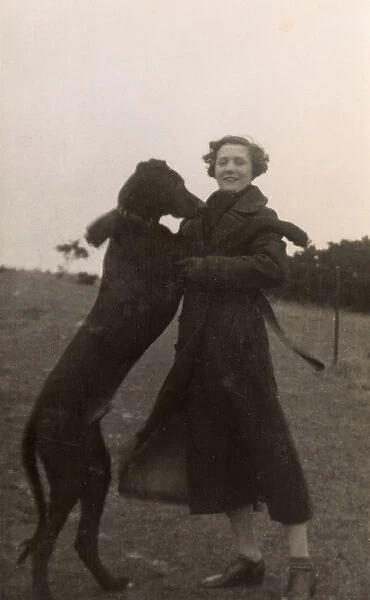 Woman with large dog in a field