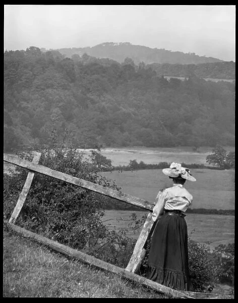Woman looking across fields