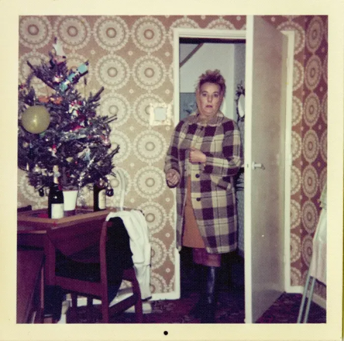 Framed Print : Woman looks surprised entering room decorated for Christmas Framed Print : Woman looks surprised entering room decorated for Christmas