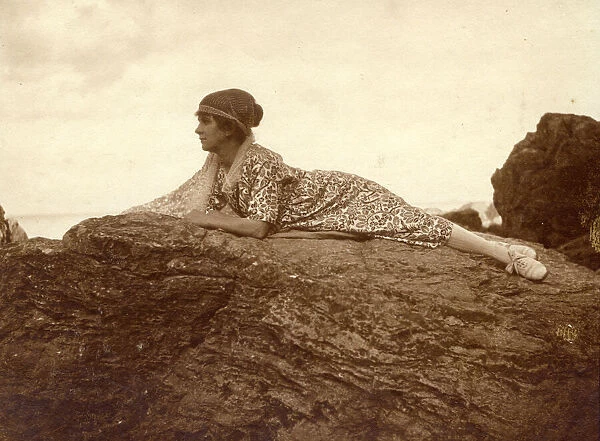 Woman lying on a rock at the seaside
