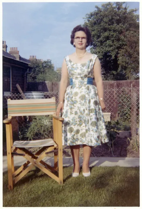 Framed Print : Woman in a neat suburban garden with garden chair Framed Print : Woman in a neat suburban garden with garden chair