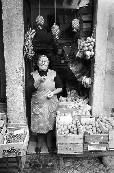 Woman outside fruit shop Lisbon