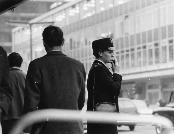 Framed Print : Woman police officer on a busy London street