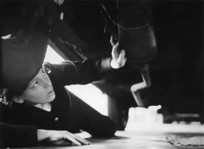 Framed Print : Woman police officer checking under a car, London Framed Print : Woman police officer checking under a car, London