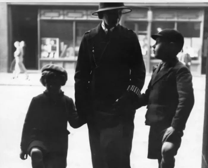Framed Print : Woman police officer holding hands with children, London Framed Print : Woman police officer holding hands with children, London