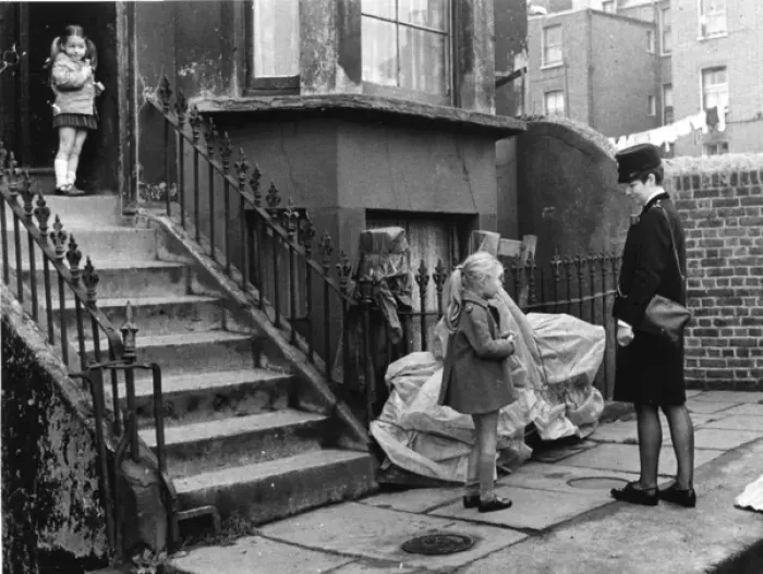 Framed Print : Woman police officer outside a house with two children Framed Print : Woman police officer outside a house with two children