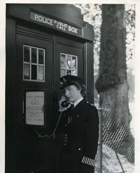 Woman police officer on telephone in a London street