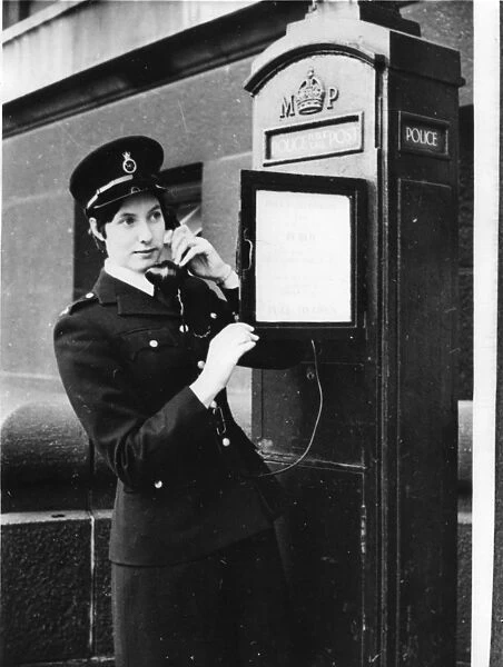 Woman police officer on telephone in a London street