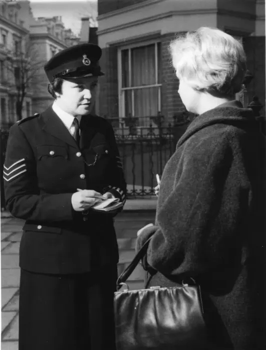 Framed Print : Woman police officer and woman with handbag Framed Print : Woman police officer and woman with handbag