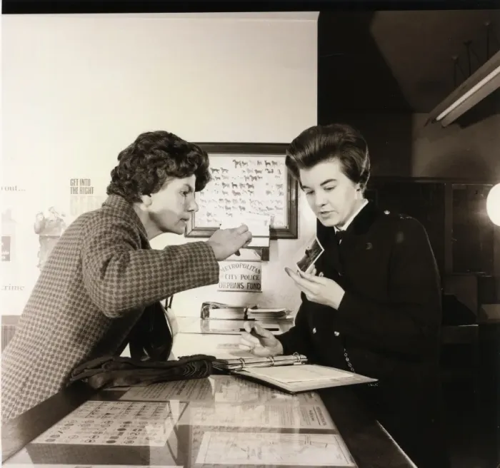 Framed Print : Woman police officer working at a police station Framed Print : Woman police officer working at a police station