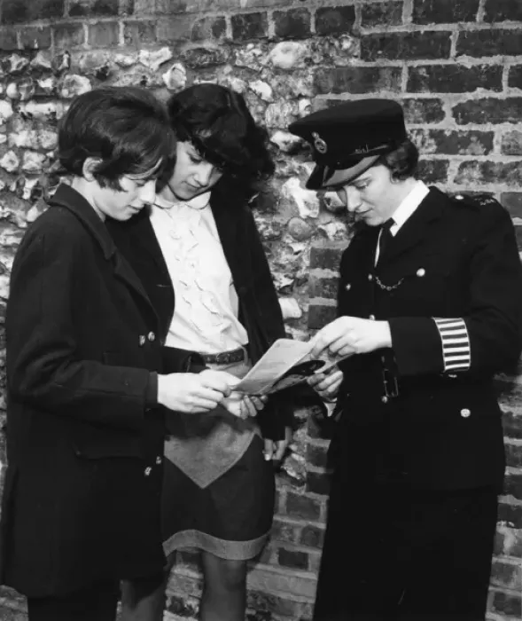 Framed Print : Woman police officer and two young women, London Framed Print : Woman police officer and two young women, London
