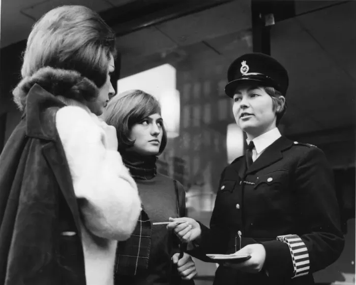 Framed Print : Woman police officer and two young women, London Framed Print : Woman police officer and two young women, London