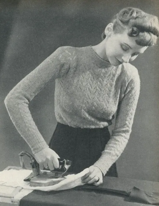 Framed Print : Woman pressing a seam under a damp cloth Framed Print : Woman pressing a seam under a damp cloth