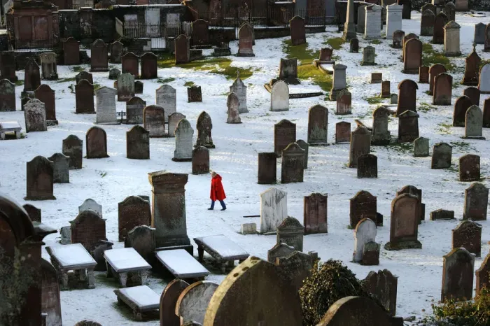 Framed Print : Woman in red coat in Kirkcudbright snowy graveyard Framed Print : Woman in red coat in Kirkcudbright snowy graveyard