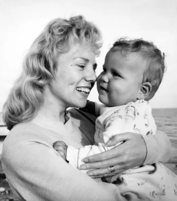 Framed Print : Woman at seaside holding a baby Framed Print : Woman at seaside holding a baby