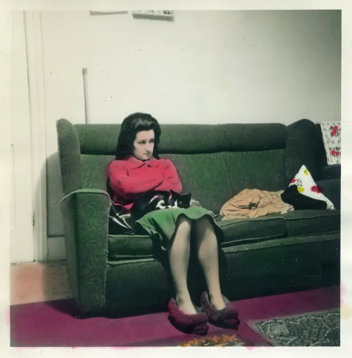 Framed Print : Woman in slippers seated on sofa Framed Print : Woman in slippers seated on sofa