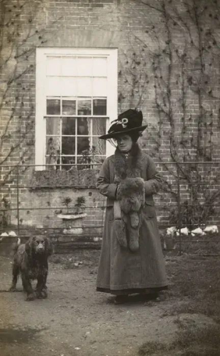 Framed Print : Woman with spaniel dog outside a house Framed Print : Woman with spaniel dog outside a house