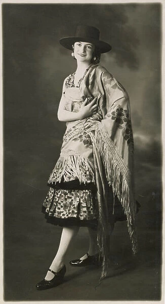A woman in Spanish costume with the characteristic Spanish shawl. Date: 1930 s