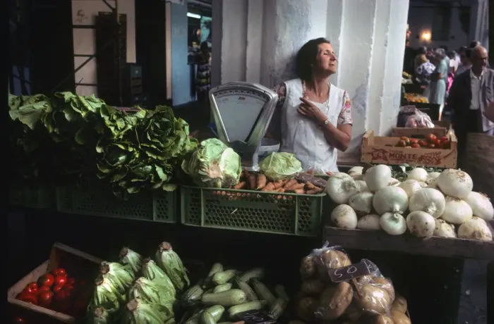 Framed Print : A woman stallholder behind her vegetable stall, Menorca Framed Print : A woman stallholder behind her vegetable stall, Menorca