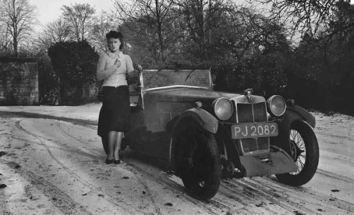 Framed Print : Woman standing by car in snowy weather Framed Print : Woman standing by car in snowy weather
