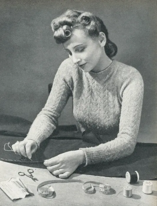 Framed Print : Woman tacking a hem before stitching it Framed Print : Woman tacking a hem before stitching it