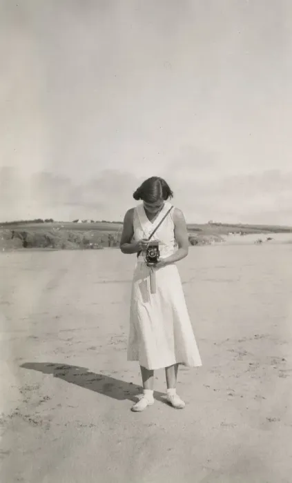 Framed Print : Woman taking a photograph on the beach Framed Print : Woman taking a photograph on the beach
