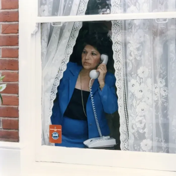 Framed Print : Woman on telephone reporting something suspicious Framed Print : Woman on telephone reporting something suspicious