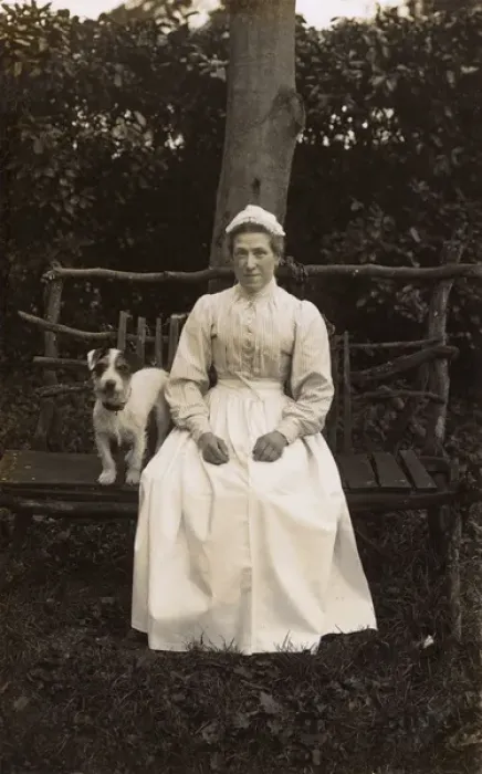 Framed Print : Woman with terrier on a bench in a garden Framed Print : Woman with terrier on a bench in a garden