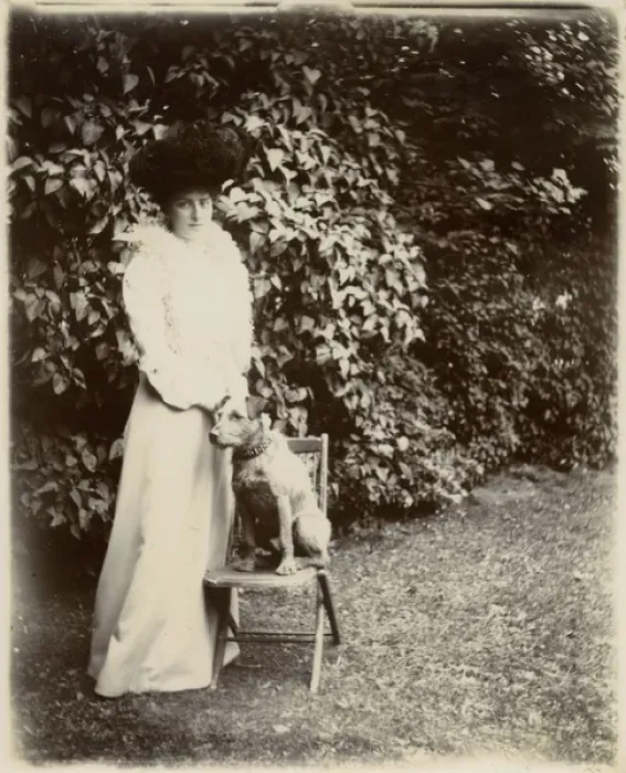 Framed Print : Woman with terrier dog in a garden Framed Print : Woman with terrier dog in a garden
