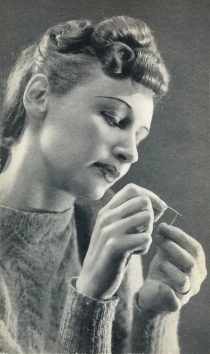Framed Print : Woman threading a needle Framed Print : Woman threading a needle