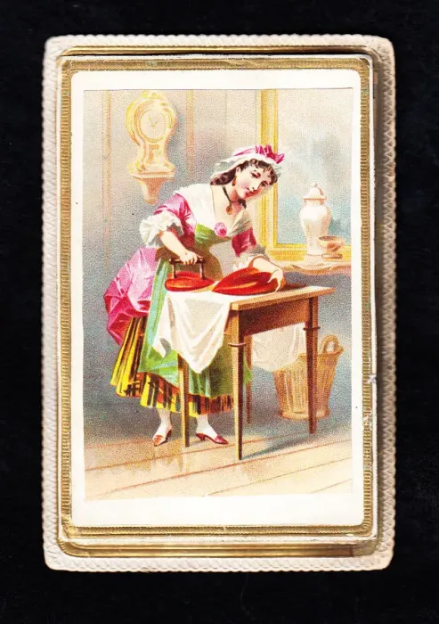 Framed Print : Woman using a heart-shaped iron on a Valentine card Framed Print : Woman using a heart-shaped iron on a Valentine card
