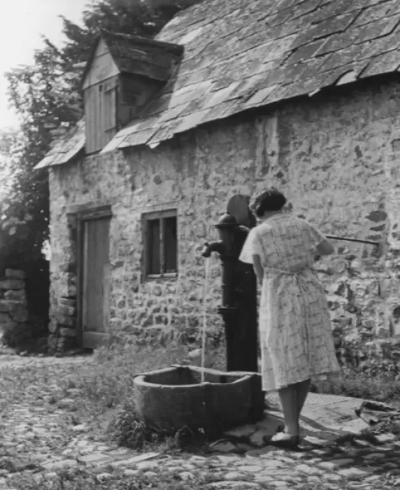 Framed Print : Woman using water pump Framed Print : Woman using water pump