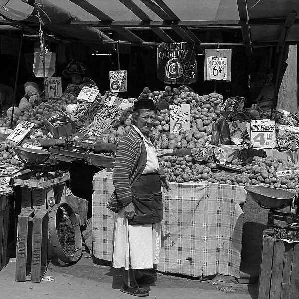 Woman and vegetable stall, East End of London