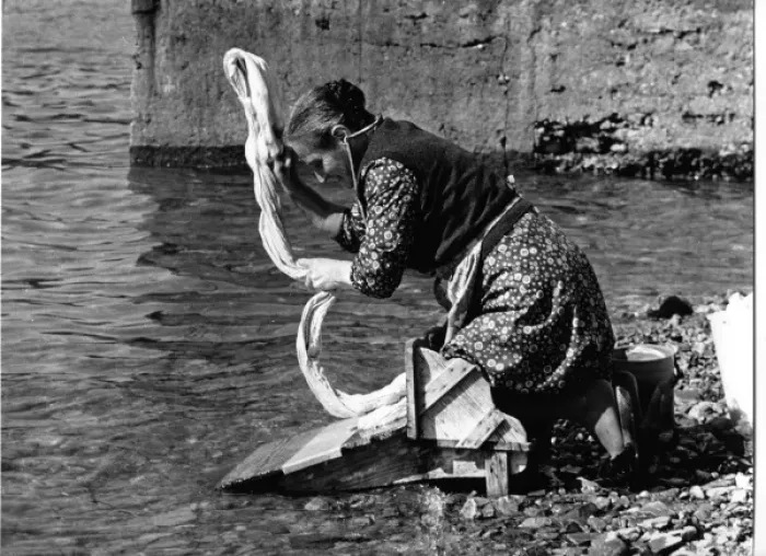 Framed Print : Woman washing a sheet in a river in Portugal Framed Print : Woman washing a sheet in a river in Portugal