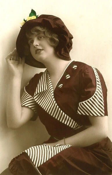 Woman wearing a hat and stripey dress