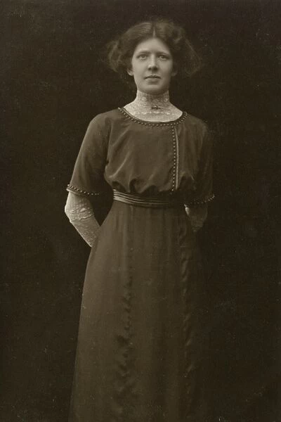 Woman wearing a long dress, gathered in at the waist