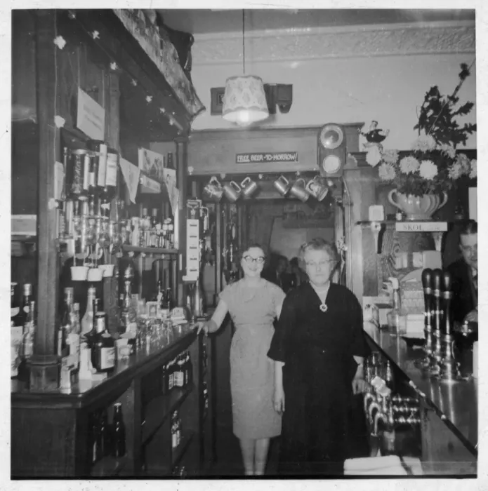Framed Print : Two Women Behind Bar Framed Print : Two Women Behind Bar