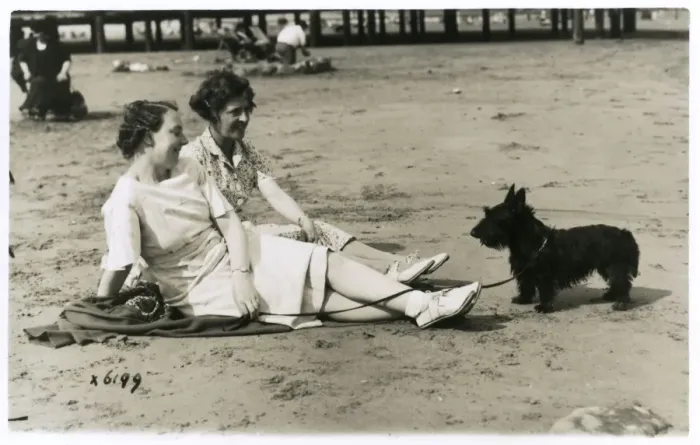Framed Print : Two women on beach with Scots terrier Framed Print : Two women on beach with Scots terrier