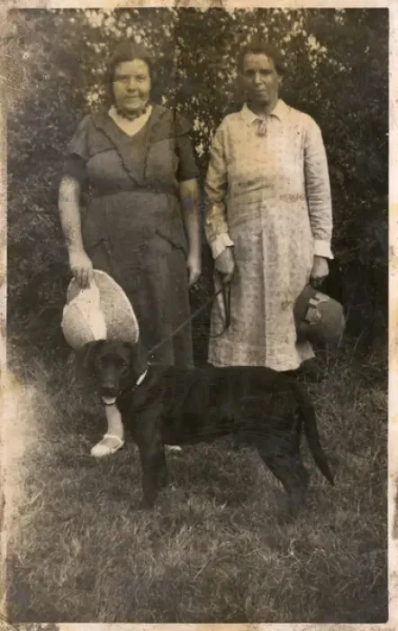 Framed Print : Two women with a dog in a garden Framed Print : Two women with a dog in a garden