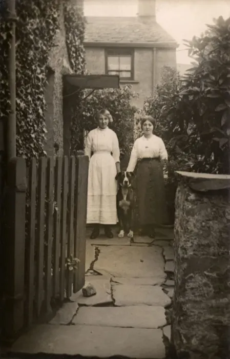 Framed Print : Two women with a dog outside a house Framed Print : Two women with a dog outside a house
