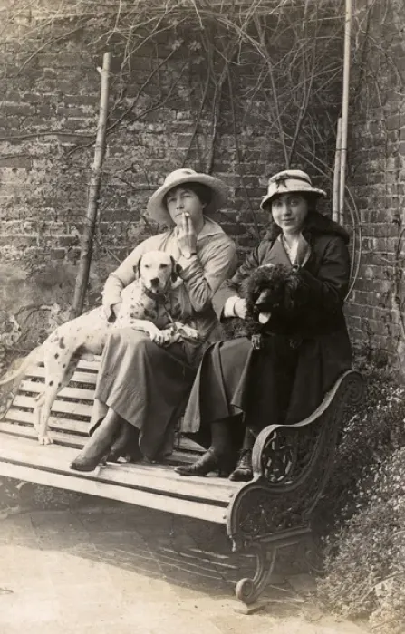 Framed Print : Two women and their dogs in a garden Framed Print : Two women and their dogs in a garden