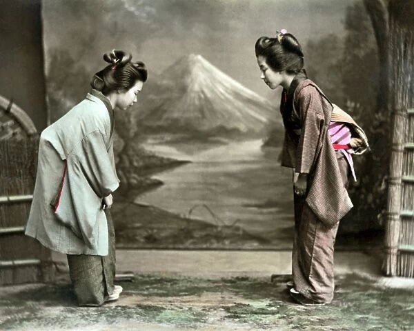 Two women in formal greeting, Japan