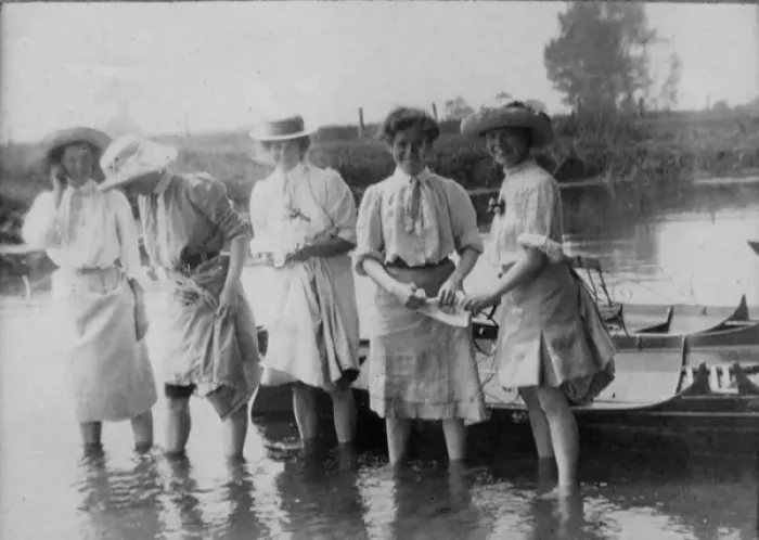 Framed Print : Women paddling in water by rowing boat Framed Print : Women paddling in water by rowing boat